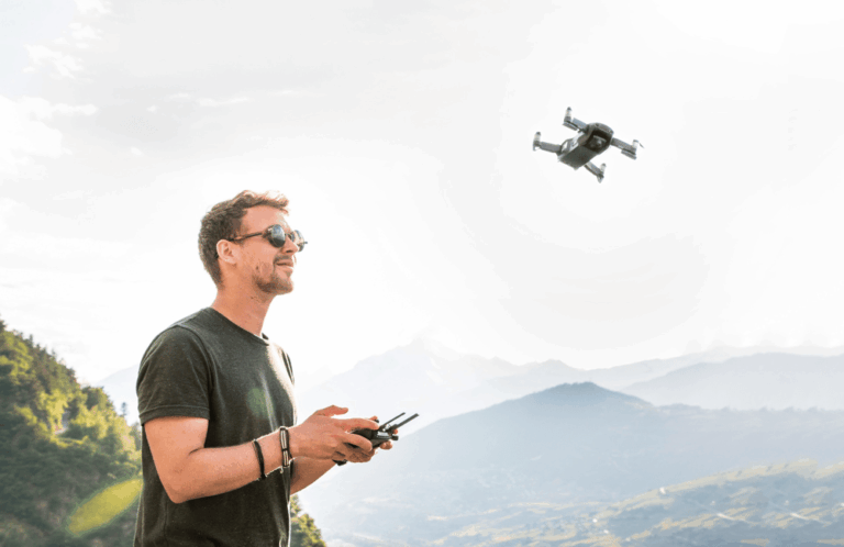 Homem de óculos com controle na mão pilotando um drone